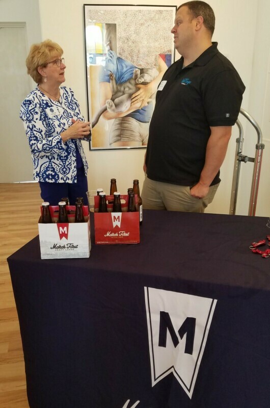MarchFirst Brewing table with man and woman talking