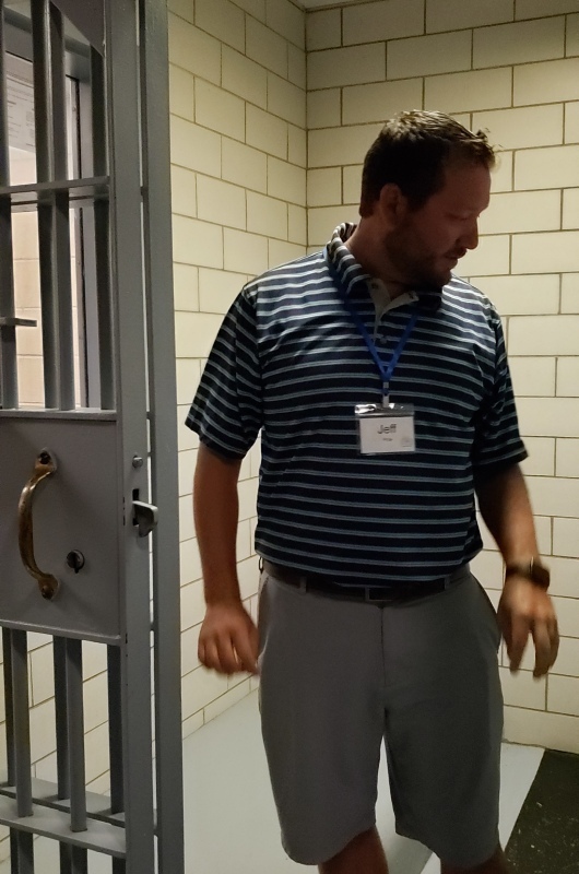 man standing in cell