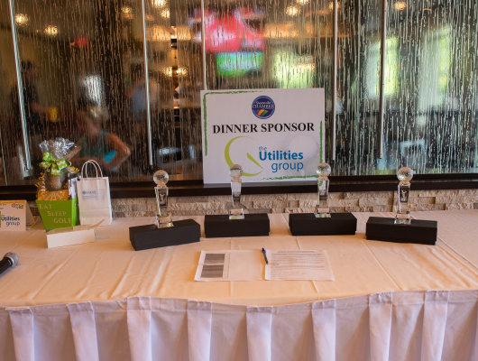 dinner sponsor Utilities Group sign and awards
