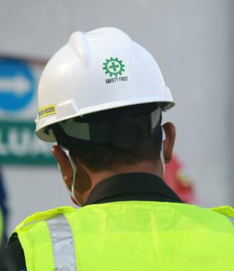 a man wearing a hardhat that says safety first