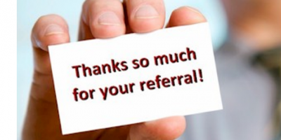 Thanks so much for your referral card in a person's hand