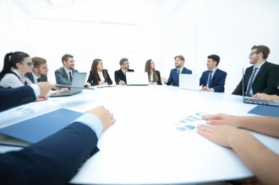 Employees dressed nice sitting at a roundtable